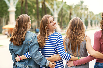 Buy stock photo Rear view of some happy teen friends standing together outdoors
