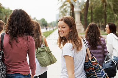 Buy stock photo A group of teen friends walking down the street together
