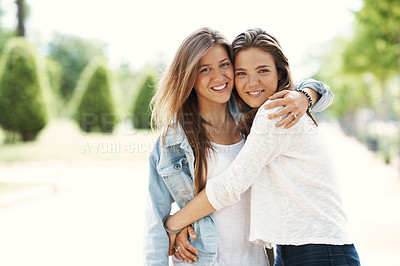 Buy stock photo Two young teen friends standing together happily while outdoors
