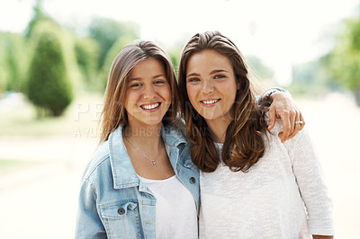 Buy stock photo Two young teen friends standing together happily while outdoors