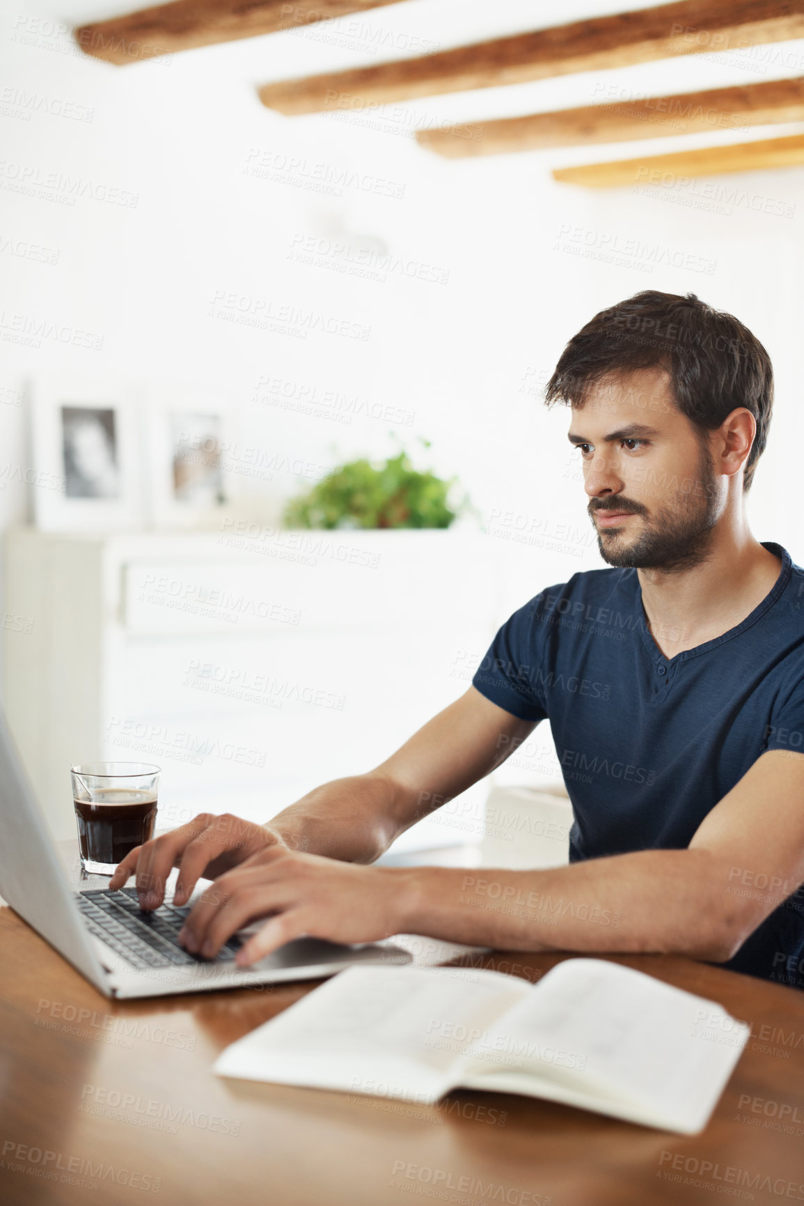 Buy stock photo Laptop, freelancer and typing with man in home for planning, morning email or ebook author. Digital publishing, research or remote work with person and book in house for editor and proofreading