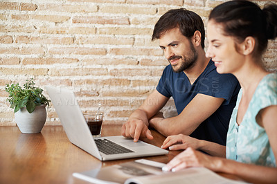 Buy stock photo A young couple sharing a laptop at home