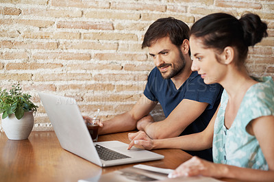 Buy stock photo A young couple sharing a laptop at home