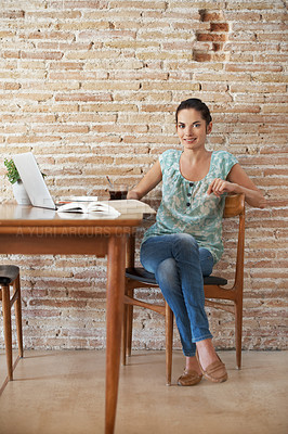 Buy stock photo Full-length portrait of a beautiful young woman doing some research using her laptop and text book