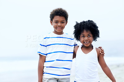 Buy stock photo A young African-American brother and sister standing on the beach smiling at the camera