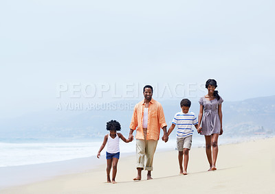 Buy stock photo A happy Afircan-American family walking on the beach