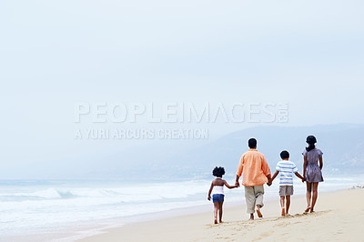 Buy stock photo A happy Afircan-American family walking on the beach