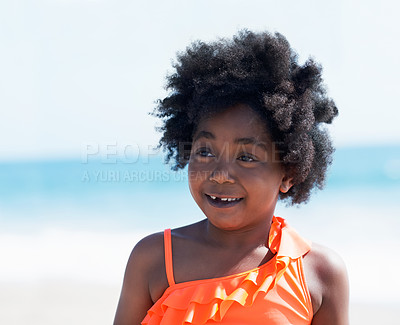 Buy stock photo A little African-American girl in an orange swimsuit on the beach smiling at the camera