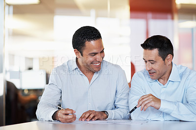 Buy stock photo A businessman discussing some paperwork with his coworker