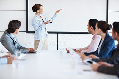 Buy stock photo An executive giving a presentation in a conference room