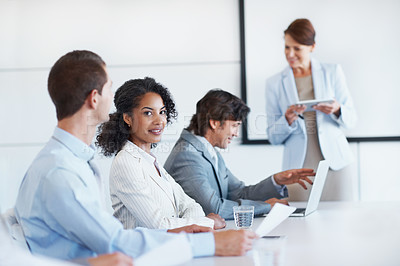Buy stock photo Portrait of a young businesswoman sitting in a board room during staff training