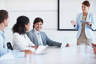 Buy stock photo Portrait of a businessman sitting beside his coworkers during a presentation