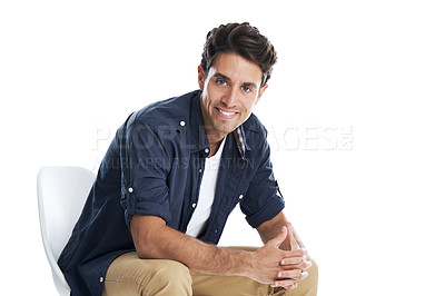 Buy stock photo Handsome young man smiling while sitting on a chair - isolated on white