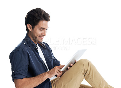 Buy stock photo Handsome man using a digital tablet and smiling while isolated on white