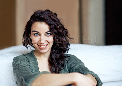 Buy stock photo A beautiful young woman leaning against her bed alongside copyspace