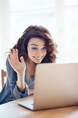 Buy stock photo A beautiful young woman waving while video chatting on her laptop