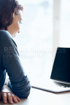 Buy stock photo A young woman enjoying a video chat on her laptop from home