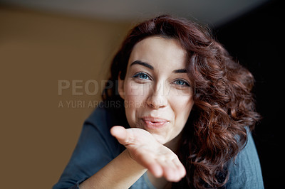 Buy stock photo A beautiful young woman blowing you a kiss - video chat POV