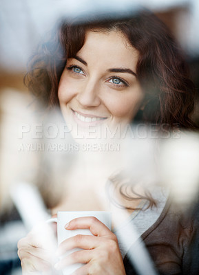 Buy stock photo A beautiful young woman looking through her window while enjoying a cup of coffee