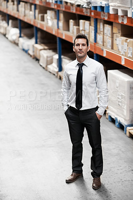 Buy stock photo Handsome warehouse manager standing in a warehouse with his hands in his pockets