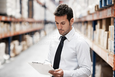 Buy stock photo Focused warehouse worker doing a stocktake while in a warehouse