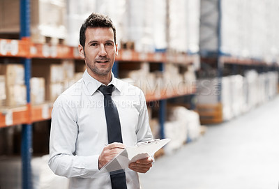 Buy stock photo Focused warehouse worker doing a stocktake while in a warehouse