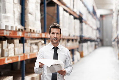 Buy stock photo Focused warehouse worker doing a stocktake while in a warehouse