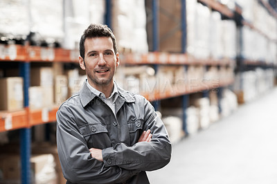 Buy stock photo Portrait of a handsome warehouse worker smiling with his arms folded