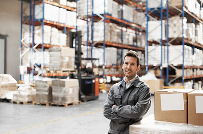 Buy stock photo Portrait of a handsome warehouse worker smiling with his arms folded