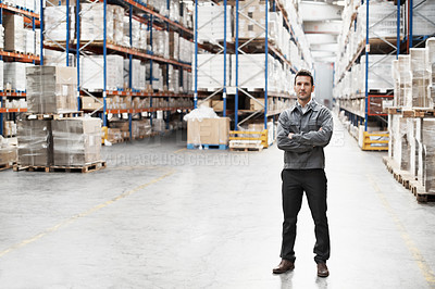 Buy stock photo Portrait of a handsome warehouse worker with his arms folded
