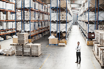 Buy stock photo Portrait of a handsome warehouse worker with his arms folded