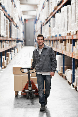 Buy stock photo Portrait of a young man using a pallet truck to move boxes in a warehouse