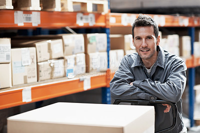 Buy stock photo Portrait of a handsome young man standing in a warehouse