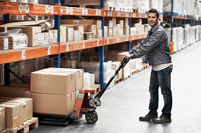 Buy stock photo Portrait of a young man using a pallet truck to pack boxes in a storehouse