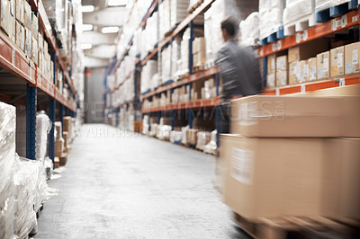 Buy stock photo A young man in a warehouse moving inventory using a pallet truck