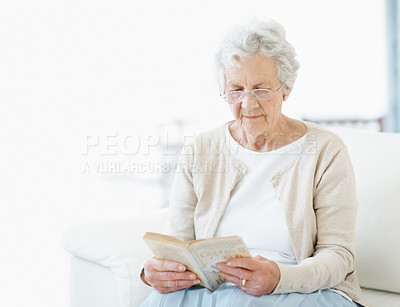 Buy stock photo Calm, book or old woman on couch with reading, fantasy novel or insight in literature hobby. Space, glasses or senior person in house with fairytale, peaceful moment or fiction story in retirement.