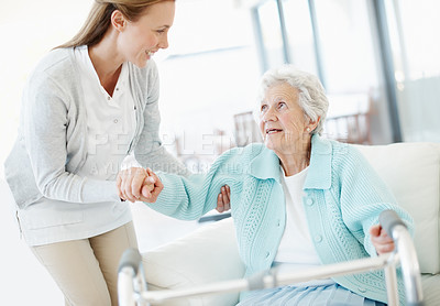 Buy stock photo Wheelchair, caregiver and old woman in facility with helping hand, support and trust in retirement care. Happy, volunteer and senior person with disability, mobility aid or assistance in nursing home