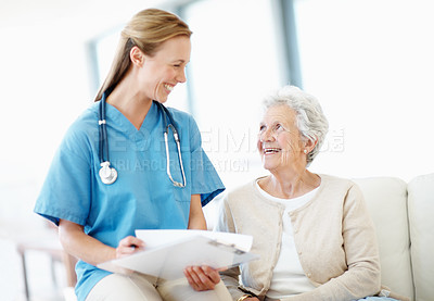 Buy stock photo Nurse, clipboard and senior woman in nursing home for support, healthcare and consultation with notes. Caregiver, smile and elderly resident on sofa with medical history, service and retirement care