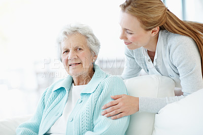Buy stock photo Smile, comfort and old woman at house with daughter, love and connection for bonding together. Portrait, person and relax in lounge with senior mother, compassion and elderly care for weekend break