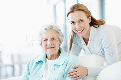 Buy stock photo Portrait, happy and old woman at house with daughter, love and connection for bonding together. Smile, person or relax in living room with senior mother, compassion and elderly care for weekend break
