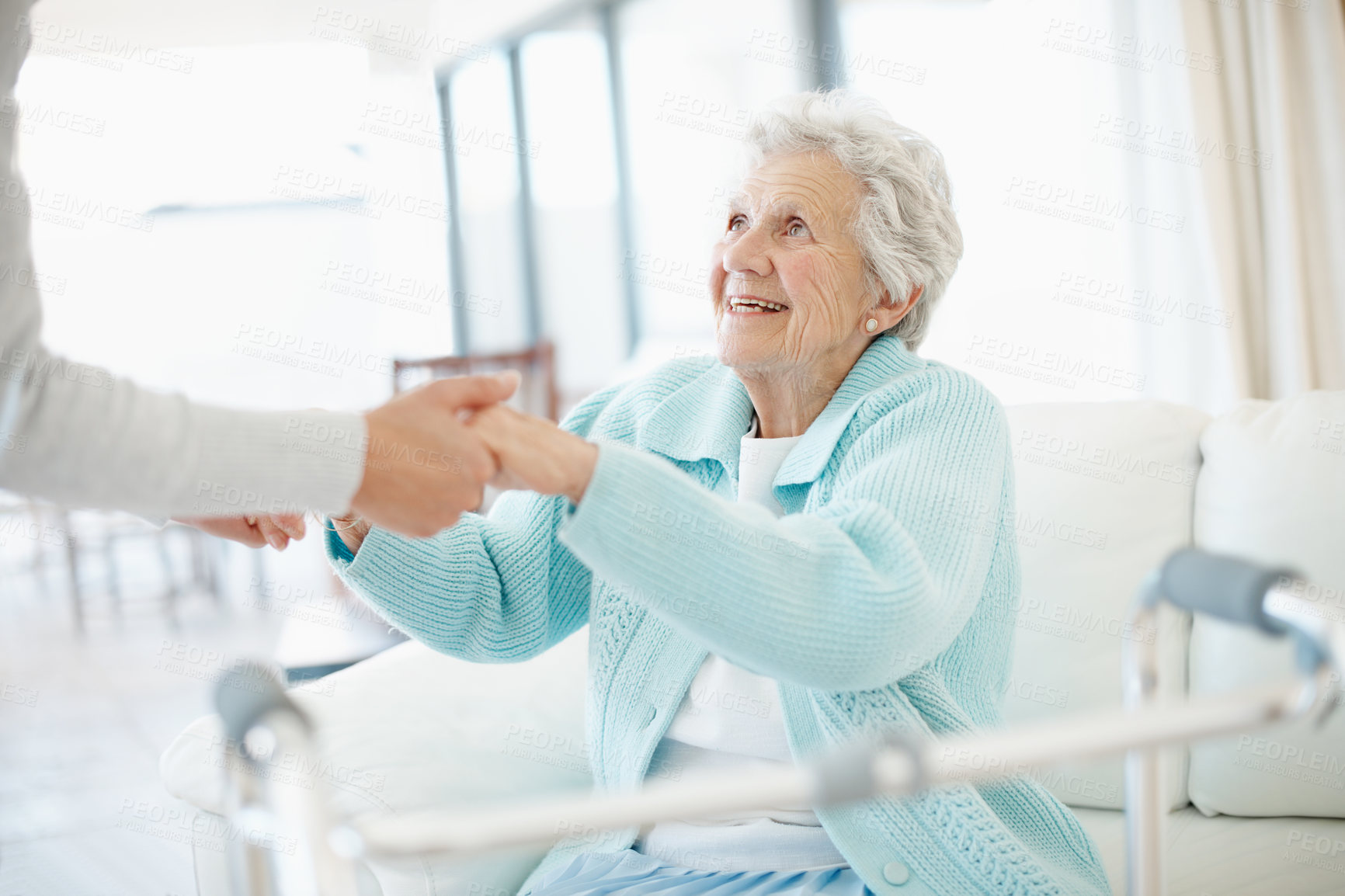 Buy stock photo Physio, walker and holding hands in nursing home with old woman, help and smile for medical support. Physical therapist, assistance and senior person with disability, mobility aid and rehabilitation.