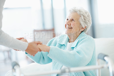 Buy stock photo Physio, walker and holding hands in retirement home with old woman, help or smile for medical support. Physical therapist, assistance and senior person with disability, mobility aid and recovery.