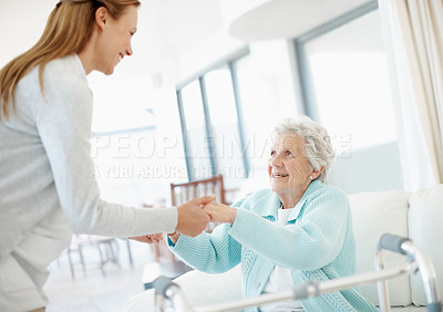Buy stock photo Wheelchair, caregiver and old woman on couch with support, helping hand or aid in retirement care. Smile, volunteer and elderly person with disability, mobility assistance or kindness in nursing home