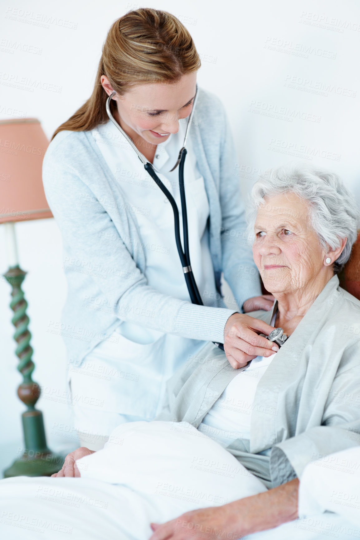 Buy stock photo Doctor, stethoscope and old woman in bedroom for heart rate, consultation or breathing evaluation. Elderly person, chest exam or healthcare worker listen with medical tools, cardiology or house visit