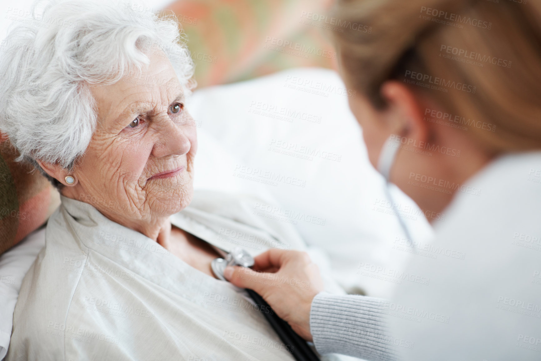 Buy stock photo Nurse, stethoscope and elderly woman in bed for homecare, healthcare and listen to heartbeat. Lungs, medical exam and chest evaluation with caregiver and senior patient in retirement at nursing home