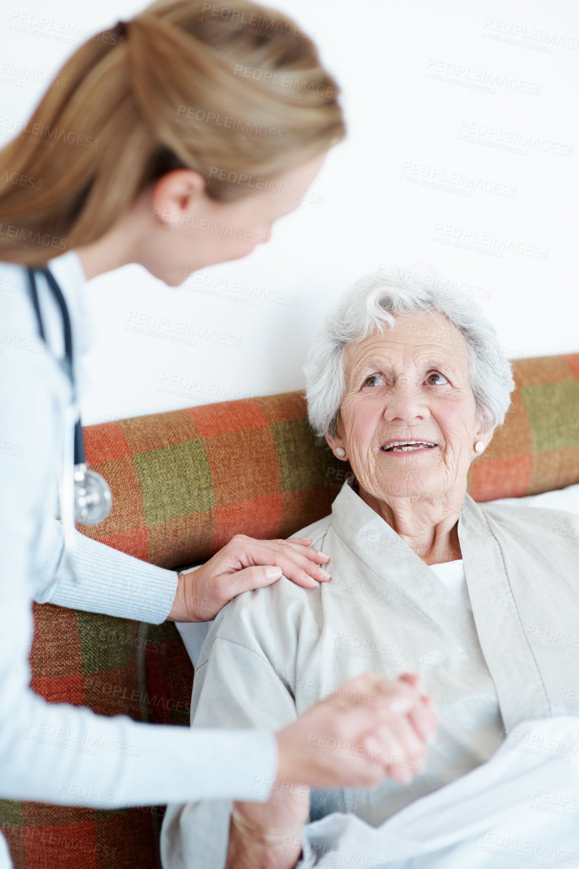 Buy stock photo Nurse, holding hands and senior woman in bed for homecare, healthcare and support with smile. Help, happy and medical service with caregiver and elderly patient in retirement at  nursing home
