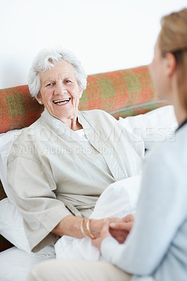 Buy stock photo Smile, caregiver and holding hands in home with old woman, good news and comfort for recovery. Portrait, nurse and consoling in bedroom with senior person, assisted living and gratitude for wellness