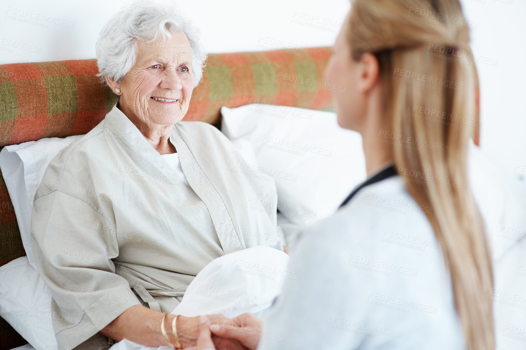 Buy stock photo Trust, caregiver or old woman on bed with holding hands, kindness or empathy in nursing home. Love, volunteer or senior person with support, happy connection or bonding together in retirement care.