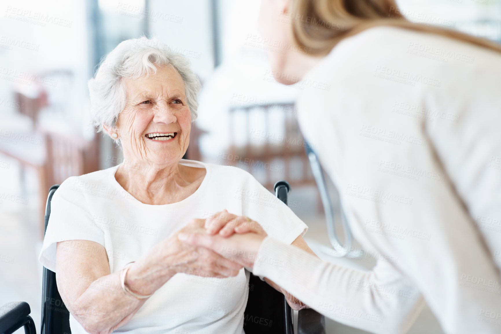 Buy stock photo Nurse, handshake and old woman in retirement home with wheelchair, greeting or smile for medical help. Healthcare worker, shaking hands and happy senior person with disability, trust or consultation.