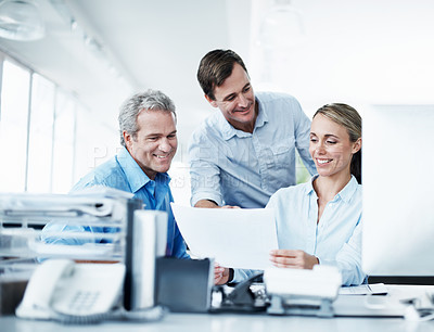 Buy stock photo Three businesspeople working together in their office